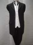 Black Prince Edward jacket with matching herringbone trousers, black shirt with white waistcoat (6kb)