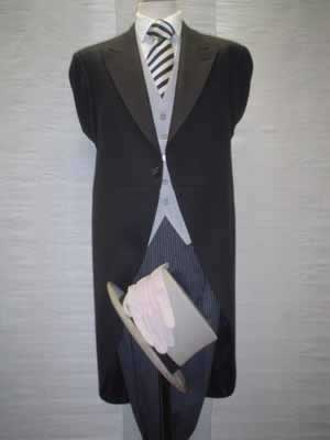 Black tailcoat with traditional grey stripe trousers, top hat and cane