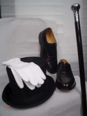 Black top hat with white gloves and cane