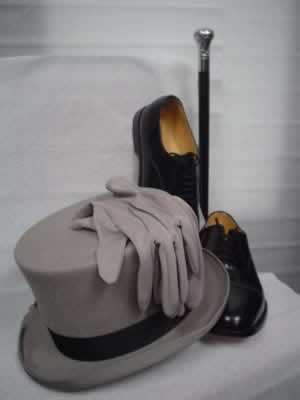 Grey top hat with grey gloves and cane