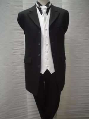 Black Prince Edward jacket with matching herringbone trousers, black shirt with white waistcoat