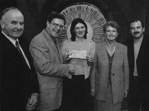 Helen receiving her cheque for 18,000