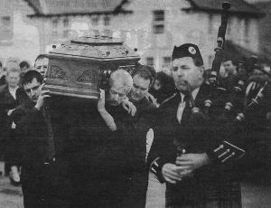 Clr. Charlie Bennett's remains are carried from the Church of the Holy Family, on left if Clr. Bennett's son Cathel.