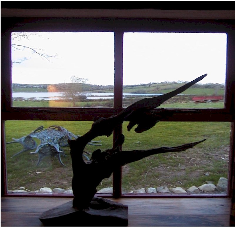A sculpture of Irish bogoak overlooking the lake
behind the cottage