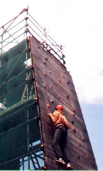 Niall scaling the climbing wall.