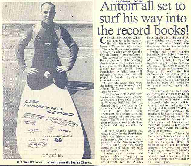 Posed photo of Antoin O'Looney on the surfboard that he crossed the English Channel with.