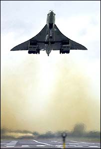 Front view of Concorde in the air taking off from runway.