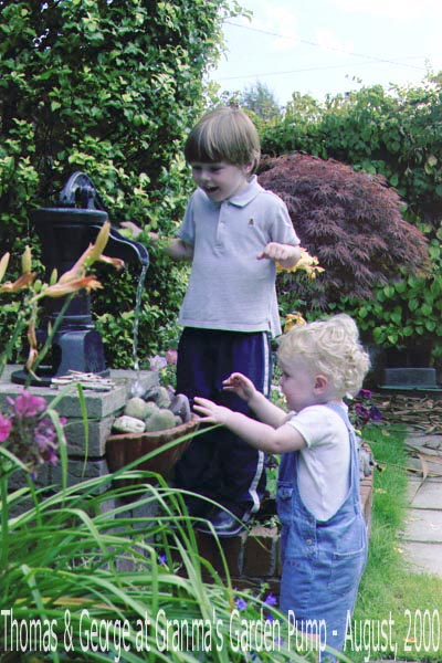 Probably the best photo that I have ever taken, it is of Thomas & George at the water pump in my garden in 2000