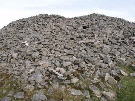 View of south side of cairn with passage entrance visible