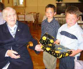 Sister Catherine receives gifts from her grandnephews.