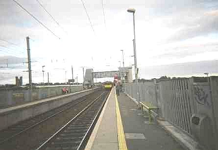 Dart from Howth approaches Clontarf Road Station in Dublin, Ireland