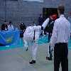 Taffee tries a head height hook kick, narrowly missing Alan.
